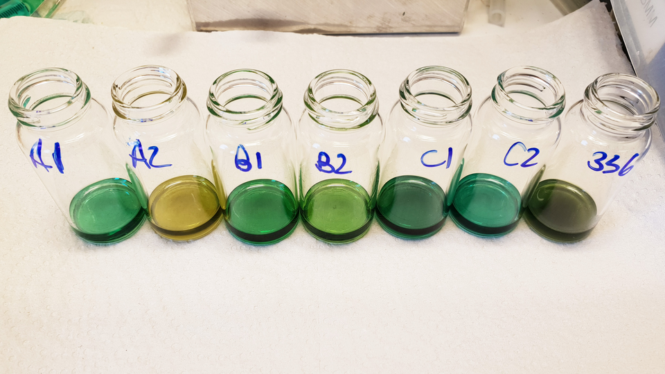 Extracts of reactions in glass containers, containing colourful compounds and salts.